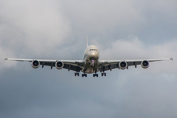 Large passenger plane landing on the airport during stormy weather