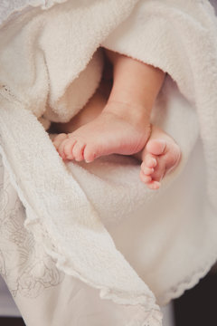 Baby feet in mommy's hand. Christening. Baptism. Orthodox