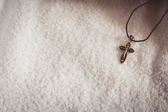 Christening accessories: little golden cross on christening blanket