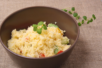 Couscous and roasted vegetables salad in a brown dish