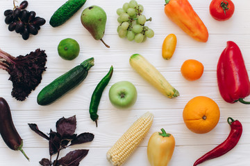 Rainbow colored fruits and vegetables on a white table. Fruit and veggies delivery concept. Top view.