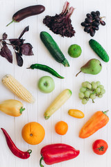 Rainbow colored fruits and vegetables on a white table. Fruit and veggies delivery concept. Top view.