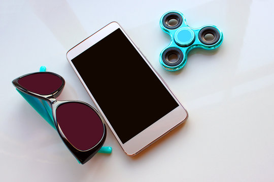 Spinner, sunglasses for the phone, spend the summer holidays. Modern toy for hands