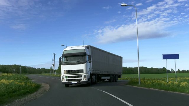 White Truck with Semi Trailer Driving on the Rural Road. Shot on RED EPIC-W 8K Helium Cinema Camera.