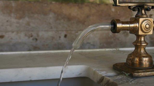 Water tap pouring healthy mineral water from thermal springs in Montecatini-Terme in Italy
