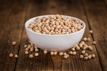 Dried Chickpeas on wooden background; selective focus