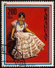 Young woman in traditional dress on postage stamp