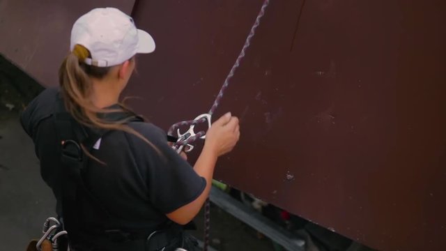 Woman climber uncouples the rope after landing