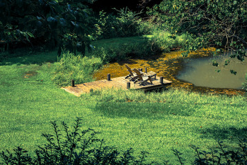 chairs by a pond