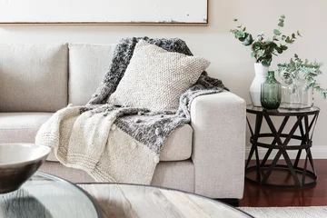 Fotobehang Textured layers interior styling of cushion sofa and throw in nuetral colors © Jodie Johnson