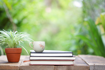 Tea cup and notebooks at outdoor