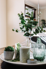 Collection of vases with greenery on a styled dining table