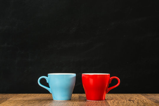 colorful blue and red coffee cups on the ancient wood
