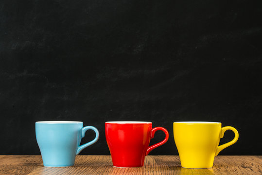 three colors of coffee cups with blue red yellow