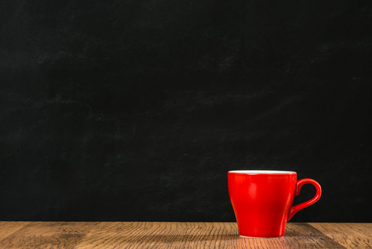 lonely red coffee cup with black wall background