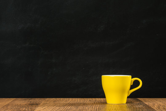 yellow coffee cup filled with hot espresso
