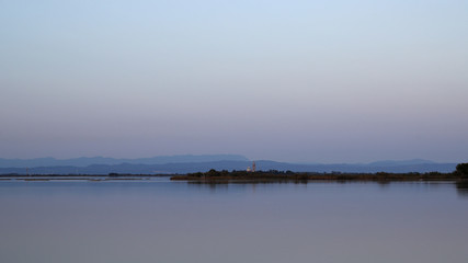Old church built on sandy island in the venitian lagoon after sunset