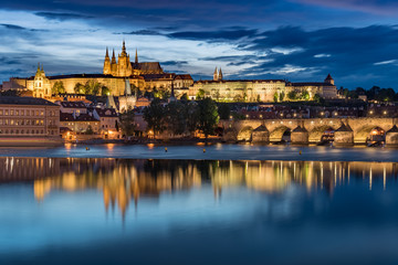 Obraz premium Prague Castle with cloudy sunset blue sky and Charles Bridge light up