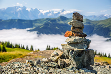 Pyramid made by stones and austrian alps in the background. Photo taken on Asitz moutain in Leogang...