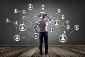 Businessman in front of a wall with sales promotion 20% 30% and 50% flying on an interface - Shopping concept