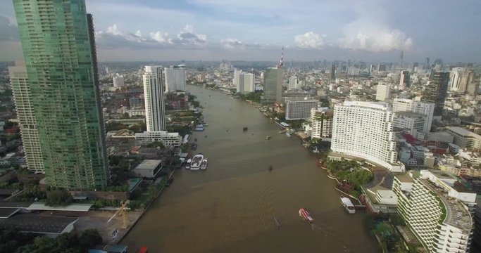 Bangkok City Skyline and Chao Phraya River, Thailand, Descending Aerial Shot
