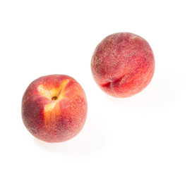 Two ripe, juicy peaches isolated on white background