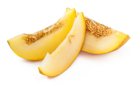 Slices of sweet, ripe yellow melon with seeds. Isolated on white
