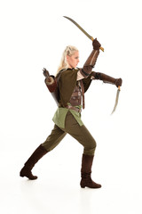  full length portrait of a blonde girl wearing green and brown medieval costume. standing pose isolated on white background.