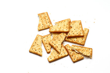 A cracker is a baked food typically made from flour. Flavorings or seasonings, such as salt, herbs, seeds, and/or cheese, may be added to the dough or sprinkled on top before baking