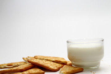 A cracker is a baked food typically made from flour. Flavorings or seasonings, such as salt, herbs, seeds, and/or cheese, may be added to the dough or sprinkled on top before baking