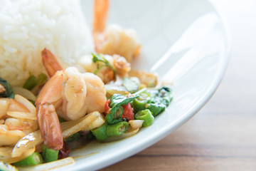 Stir-Fried Shrimps and Basil Rice Thai Food style has ready to served on white plate.