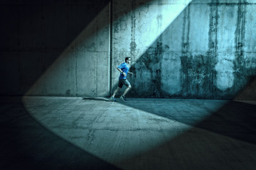 Side view male runner arcades spotlight