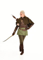 Obraz premium full length portrait of a blonde girl wearing green and brown medieval costume. standing pose isolated on white background.