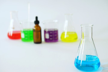 Group of Laboratory Glass Erlenmeyer Conical Flask and Beaker filled with chemical liquid for a chemistry experiment in a science research laboratory.