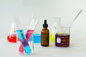 Group of Laboratory Glass Erlenmeyer Conical Flask and Beaker filled with chemical liquid for a chemistry experiment in a science research laboratory.