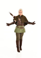  full length portrait of a blonde girl wearing green and brown medieval costume. standing pose...