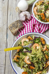 Green tagliatelle with seafood. Mussels; Prawns