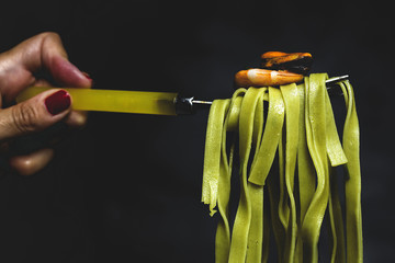 Green tagliatelle with seafood.