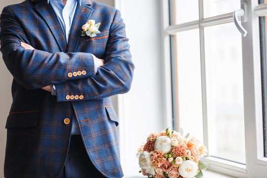 Groom With A Wedding Boutonniere In A Checkered Suit