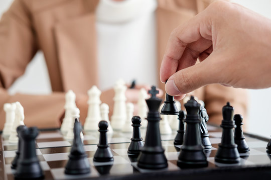Hand of a business making a chess movement. Business concept strategy, leadership, team and success