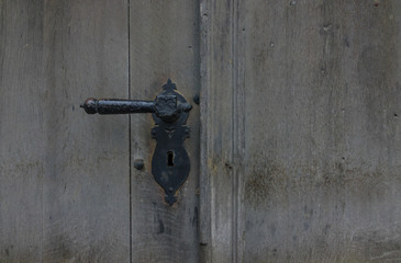 The old vintage door with handle and keyhole
