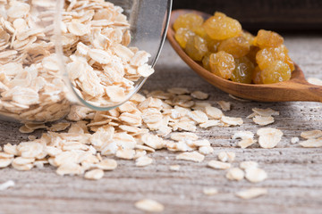 Dry rolled oat flakes oatmeal on old wood table