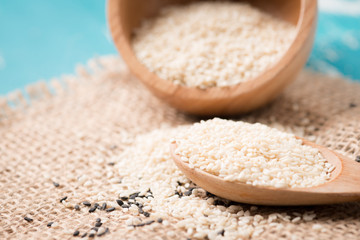 Sesame seeds and sesame oil on a old wooden table