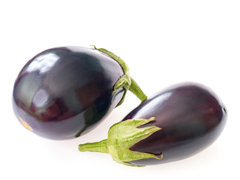 Two raw, ripe, shiny violet eggplant, isolated on white