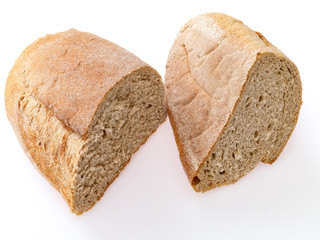 Loaf of rye bread cut in two pieces. Bottom side, close-up