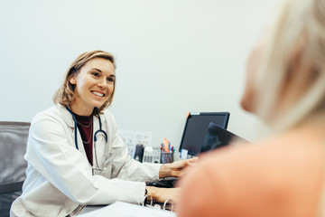 Female doctor listening to her patient during consultation