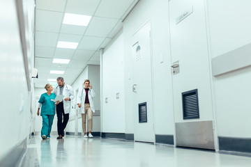 Medical team walking down hallway at the hospital