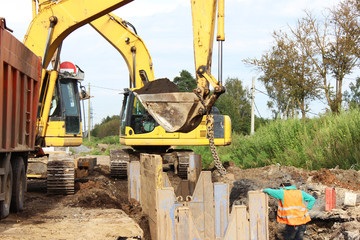 Fototapeta premium Installation of metal structures - immediate support for draining the soil at the construction site of the road in marshland