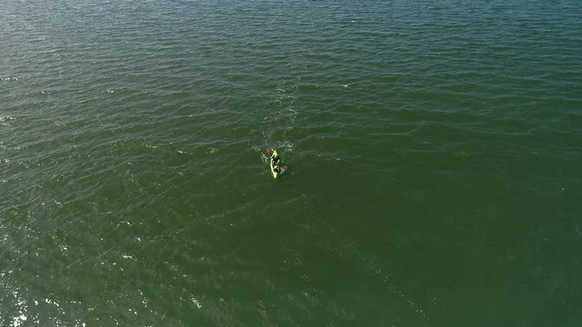 Aerial Reveal of Man on Long Ocean Kayak Adventure at Sea