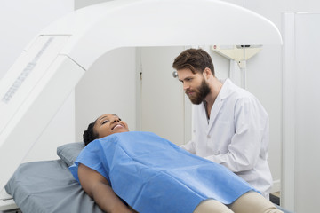 Doctor Looking At Female Patient Undergoing Breast Checkup